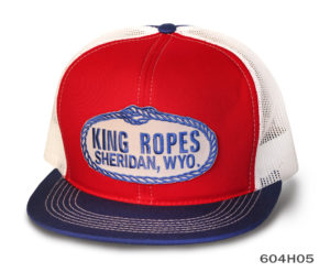 A red, blue, and white cap with king ropes label