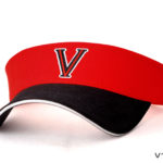 A red and black visor with the letter v on it.