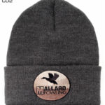 A black knitted cap with a brown and black label