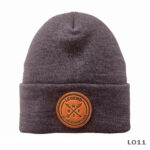Gray beanie with leather patch design.