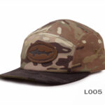 Camouflage cap with leather shark emblem.